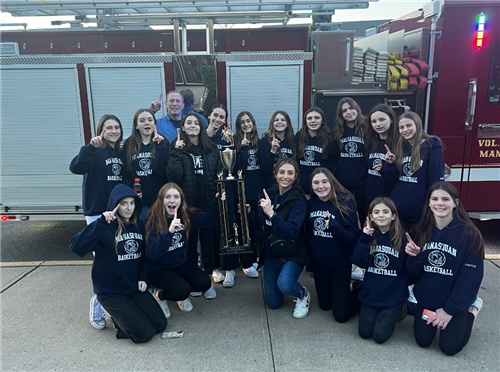 MES Girls Basketball in front of fire truck